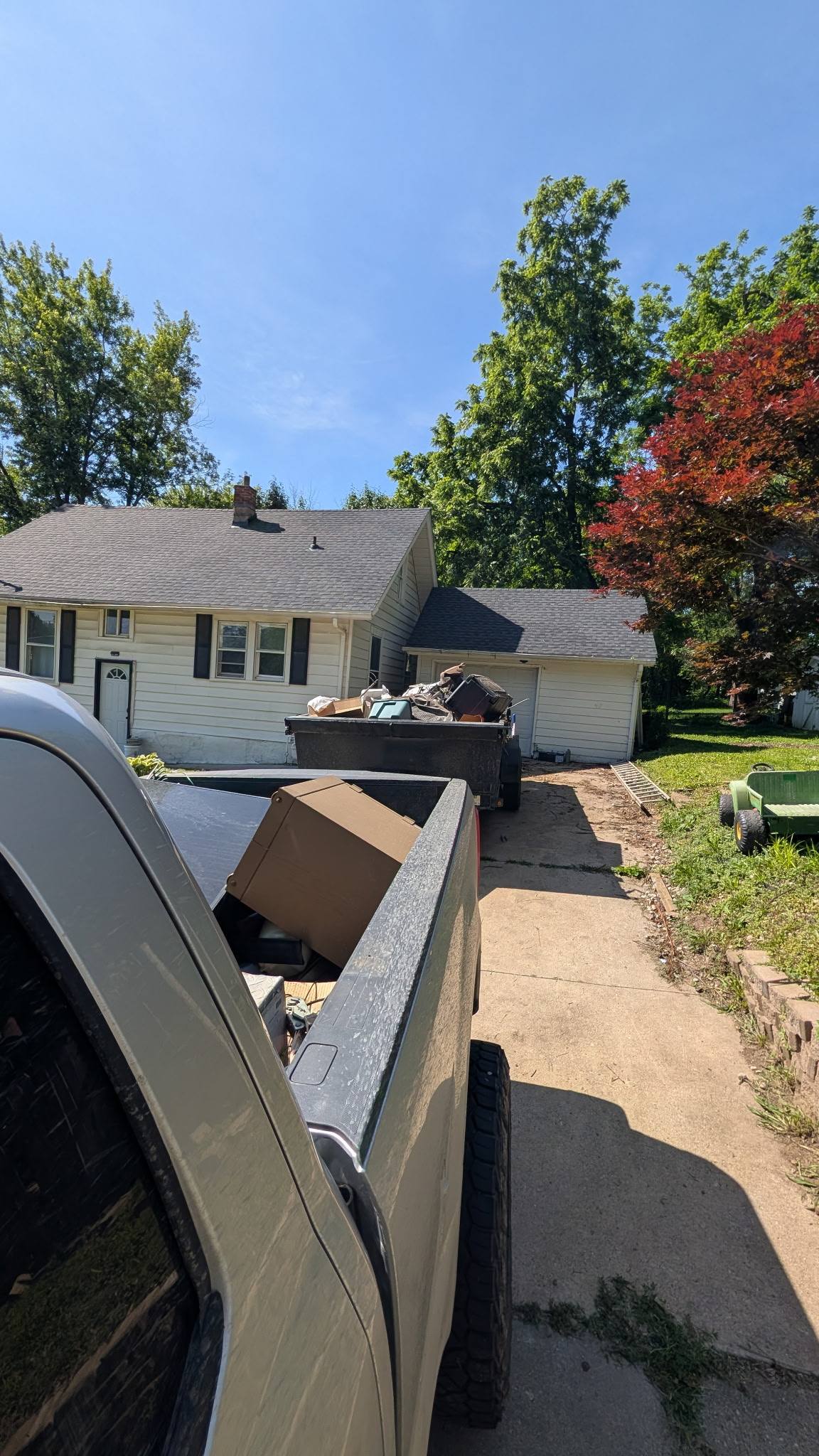 Two fully loaded trailers parked at a residential property