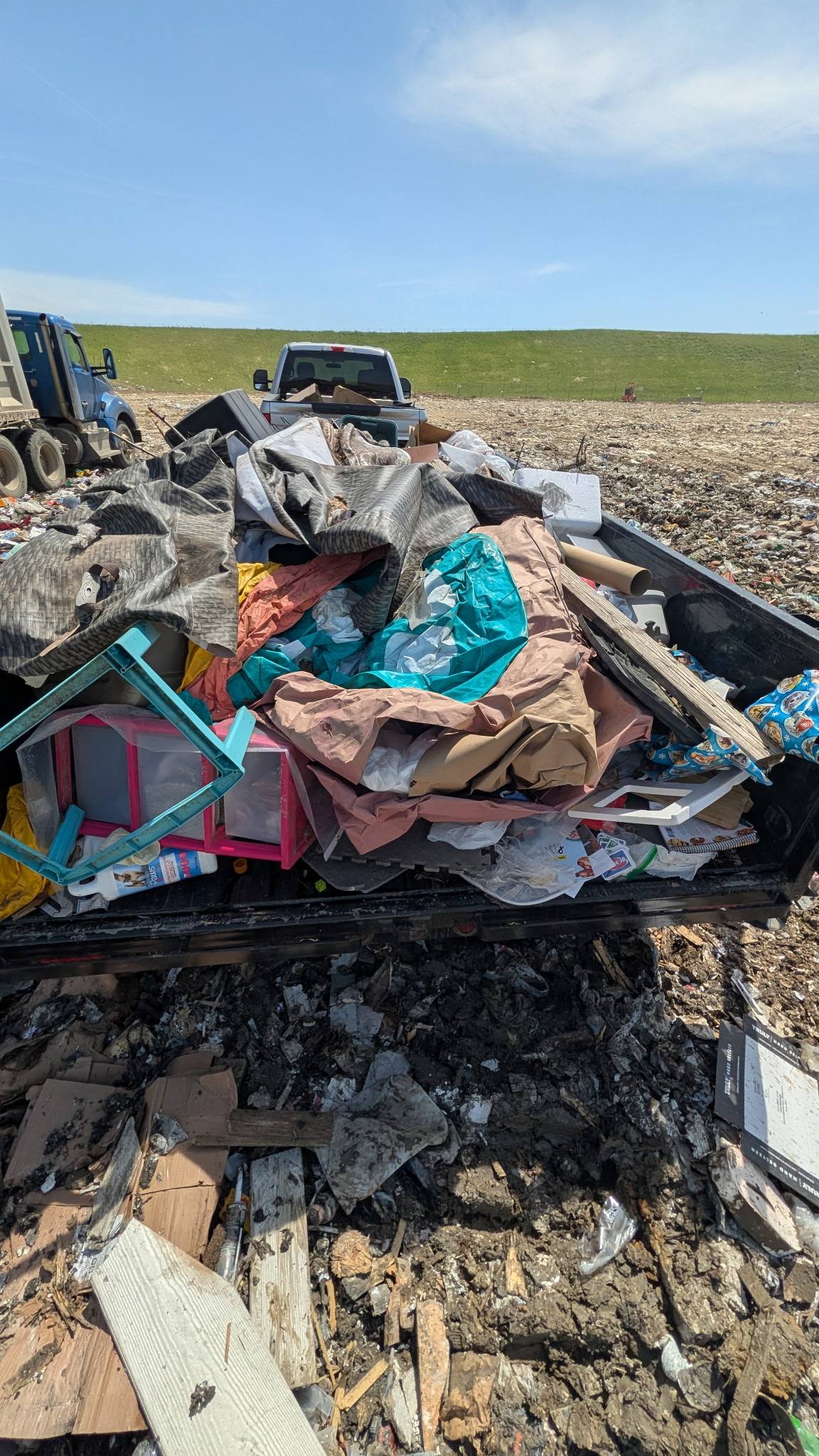 Truck bed loaded with junk at the dump site for disposal