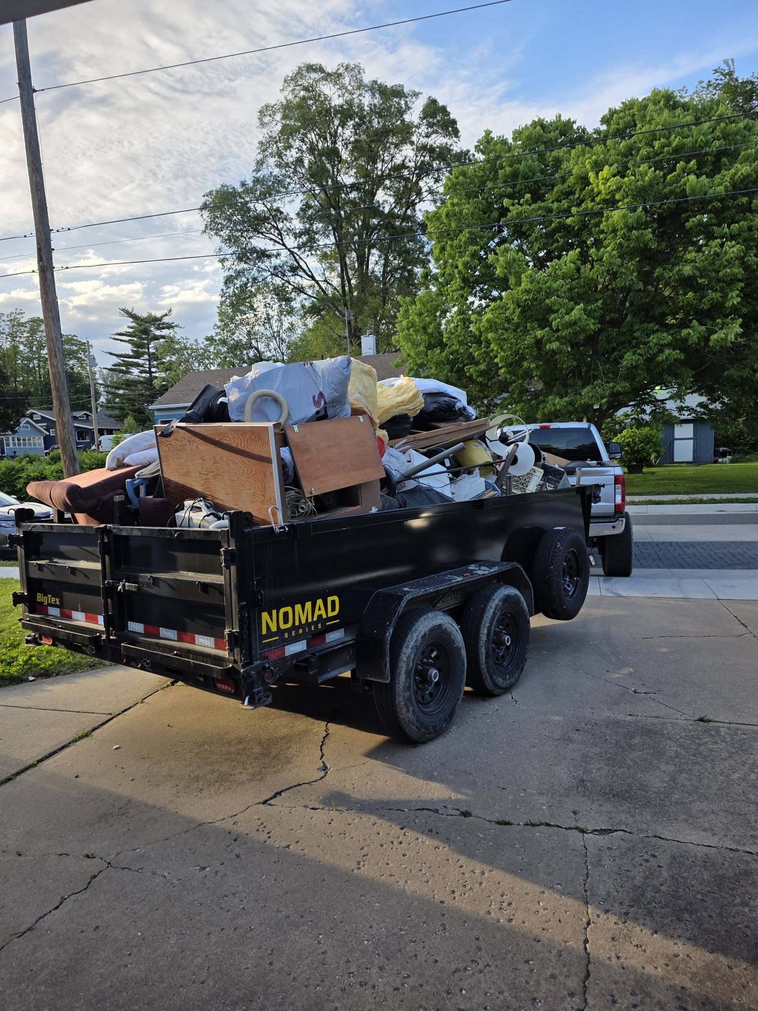 Fully loaded dump trailer packed with junk and debris