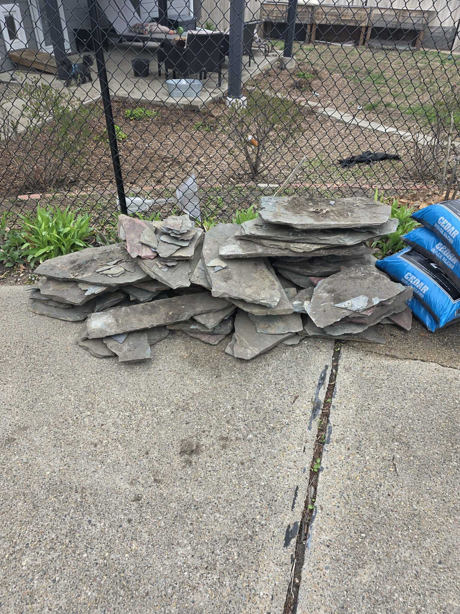 Large stone debris pile in driveway before removal